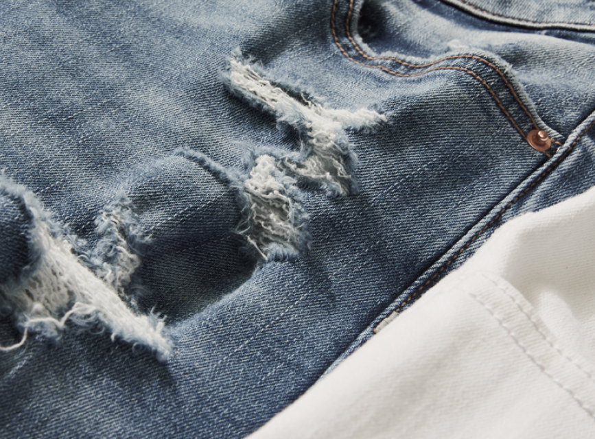 Distressed denim fabric on a pair of jeans.